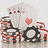 A stack of casino chips next to a set of four Ace cards.