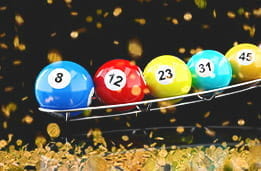 Colourful bingo balls coming out of a bingo hopper.