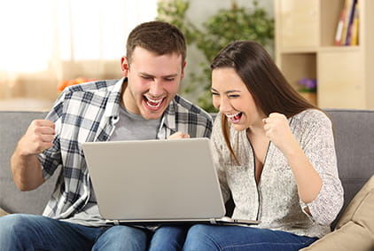 Couple Betting Online with a Laptop