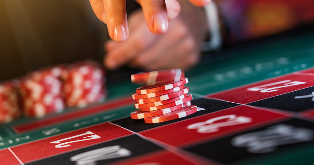 An Image of a Roulette Wheel and Chips