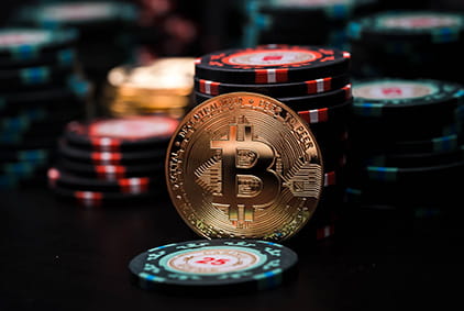 The Bitcoin Symbol Alongside Chips and Playing Cards