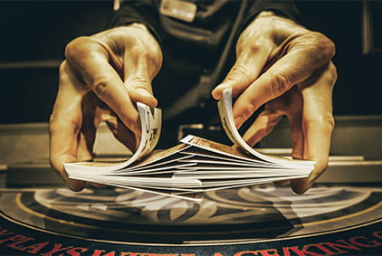 Hands Shuffling a Deck of Playing Cards