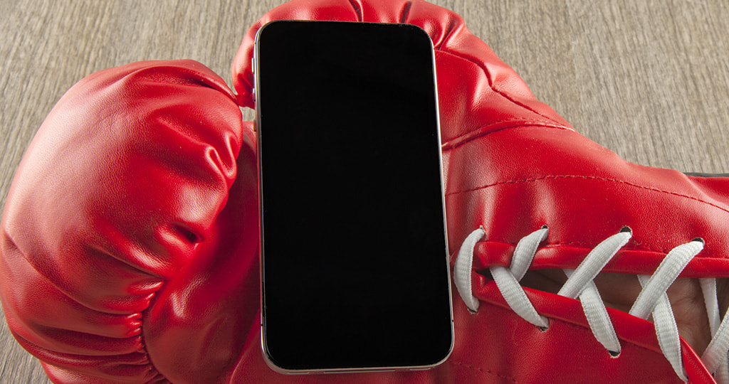 Boxing Glove Next to a Smartphone