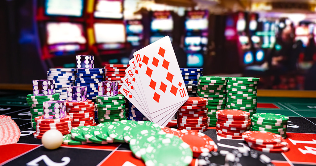 Playing cards surrounded by dice and chips