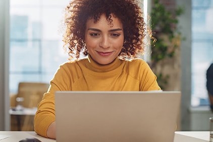 A picture of a woman sitting at a computer