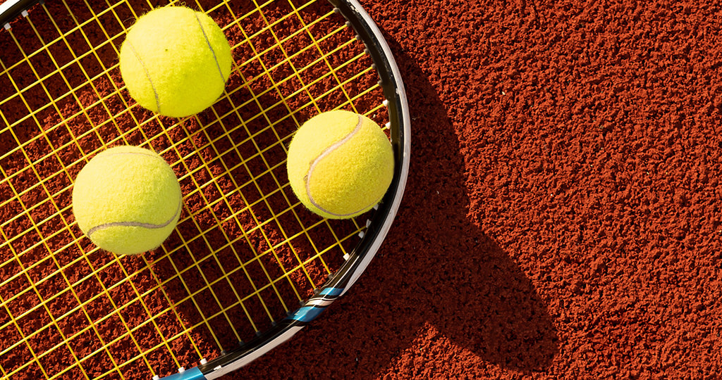 Foot, racket and tennis ball on clay 