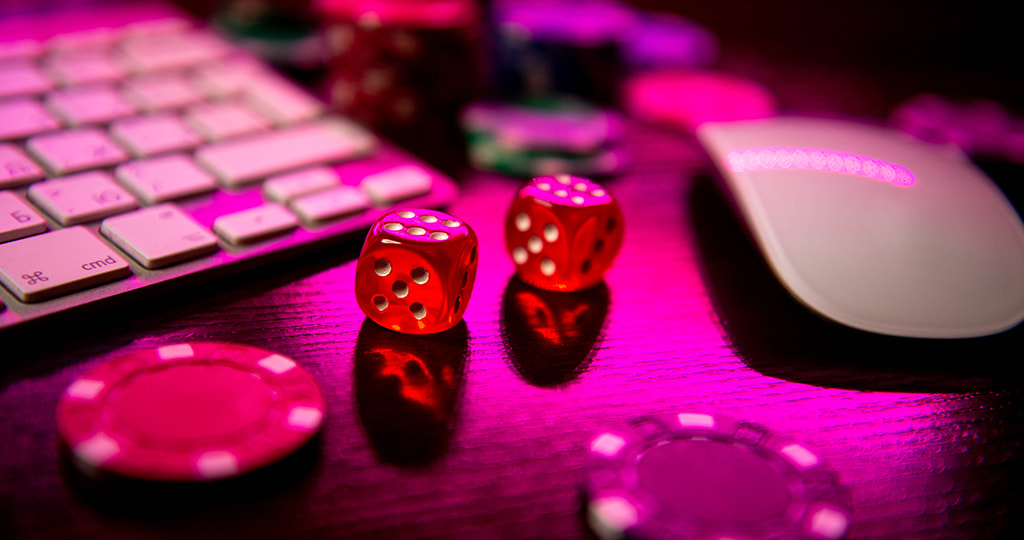 Stacks of dice and chips in front of a keyboard