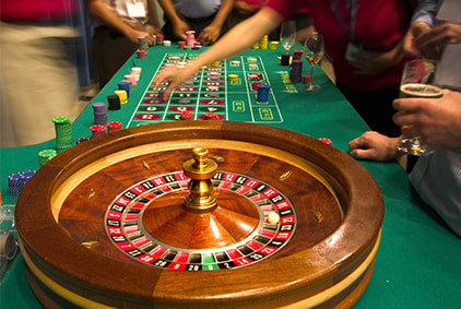 Multiple hands placing chips on a roulette table