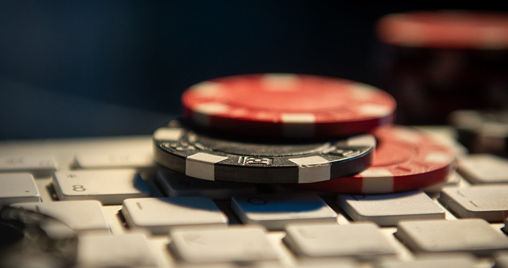 Stacks of gambling chips on a desktop keyboard