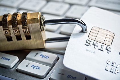 A padlock and credit cards on a keyboard