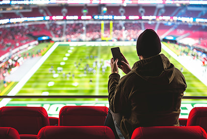 Someone holding a phone in front of an NFL field