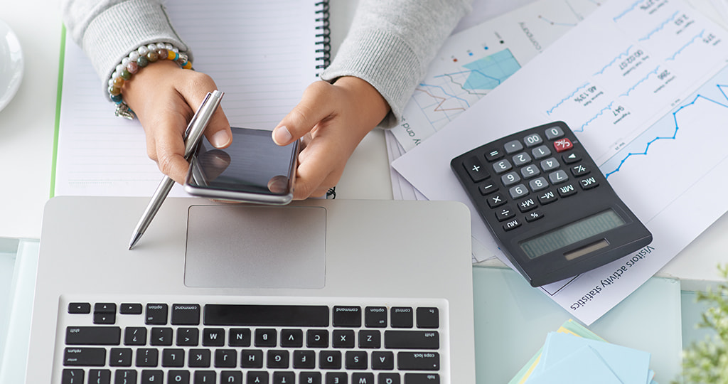 Writing calculations on paper while holding a smartphone