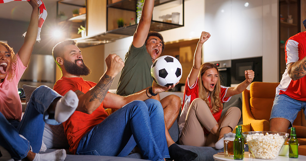 Football fans gathered around a bookmaker’s screen