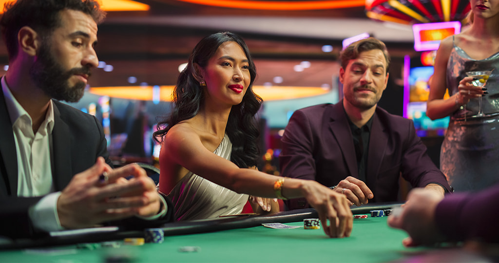 A group of people sitting around a betting table