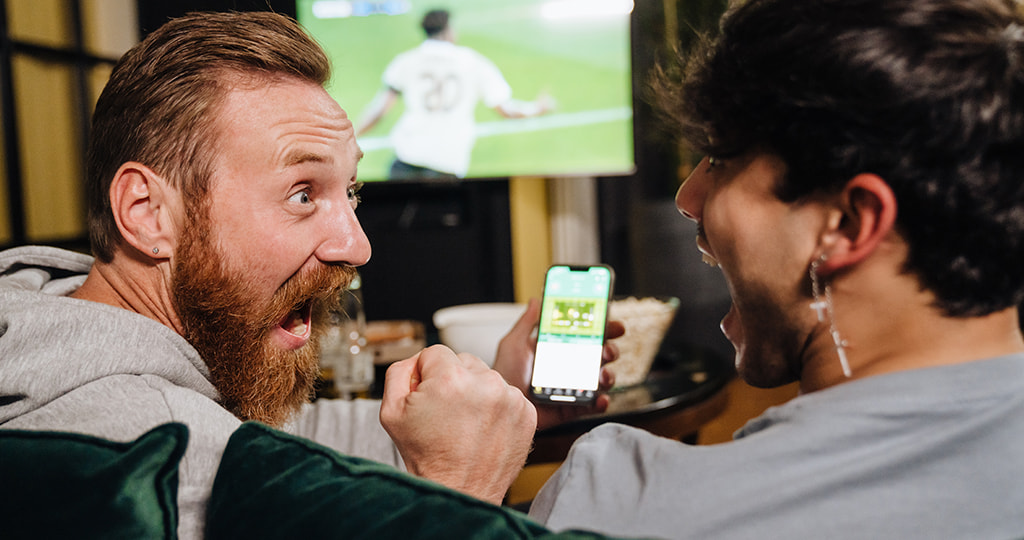 People watching sports events and betting markets on a big screen