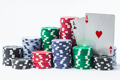 Stacked chips sitting by a deck of cards